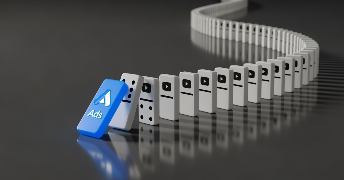 A single blue domino with an ads logo tipping over to start a chain reaction of hundreds of white YouTube dominoes.